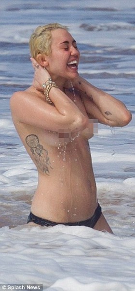 Miley Cyrus topless in the ocean with boyfriend Patrick Schwarzenegger 
